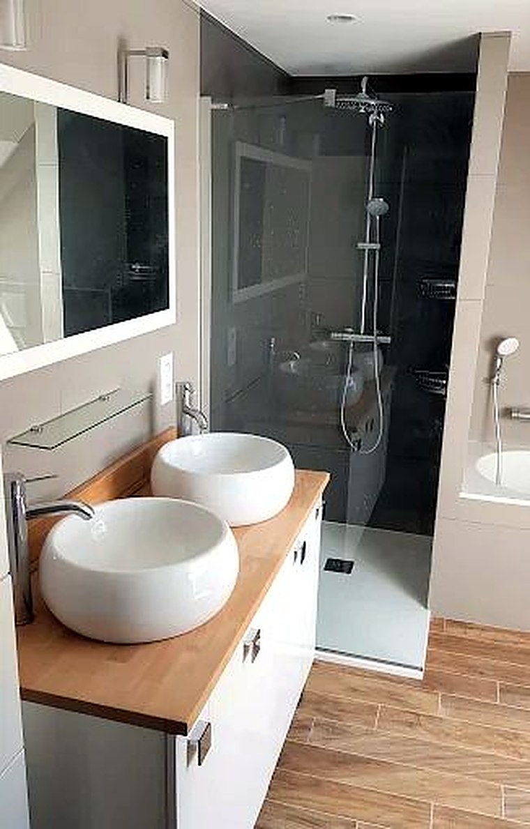 Salle de bains avec double vasque sur plan bois et douche à l’italienne